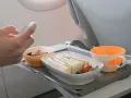 Na tacy w samolocie Wizzair kanapka, babeczka i napój. Zastanawiasz się, czy można wziąć jedzenie do samolotu Wizzair? Tak, można!